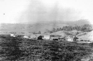 Hagmaier Ranch, ca. 1931-1941. (Source: Daniel Hagmaier. Credit: Point Reyes National Seashore Museum, HPRC 58080.) Hagmaier Ranch: Landscape view looking NE with ranch buildings and house. Wide and long view. Rolling grass covered hills in distance.